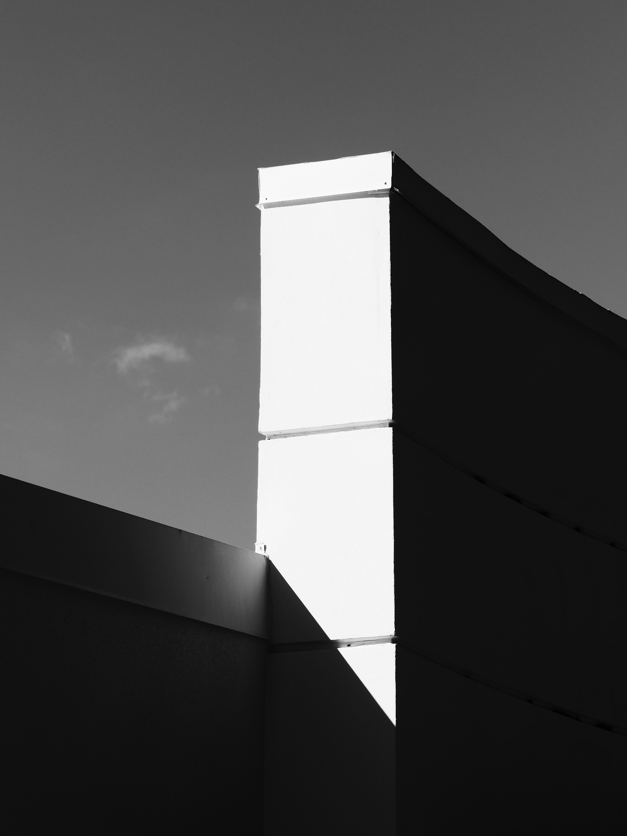 Illustrative monochrome architectural photograph with strong geometric shadow